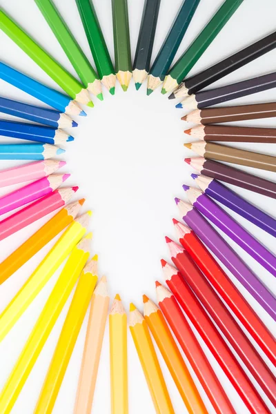 Colored pencils arrange in light bulb shape — Stock Photo, Image