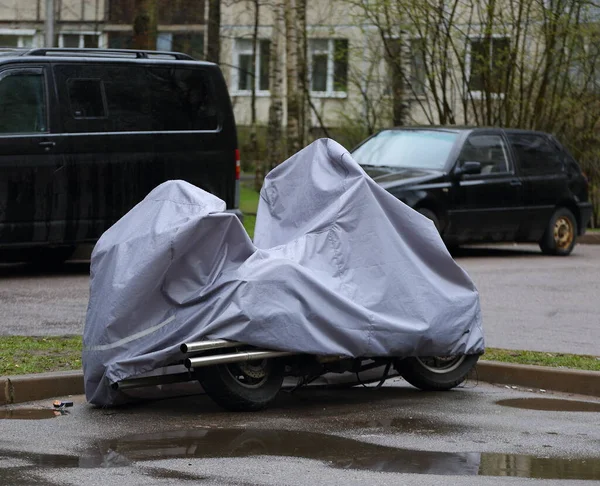 The motorcycle is covered with a cover