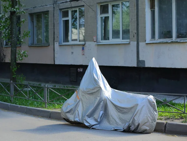 The motorcycle is covered with a cover