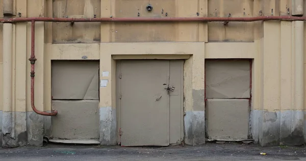 Three metal doors to the utility rooms of a residential building