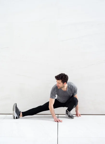 Man stretches leg-Space for text — Stock Photo, Image