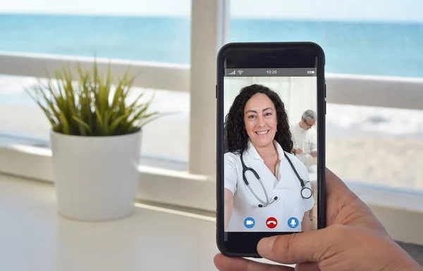 Smartphone video call to talk to doctor woman — Stock Photo, Image