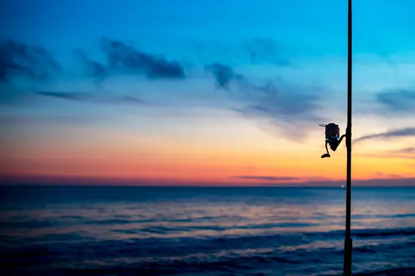 Detail Fishing Reel Beach Sunset Unfocused Background Sea Colorful Sky — Stock Photo, Image