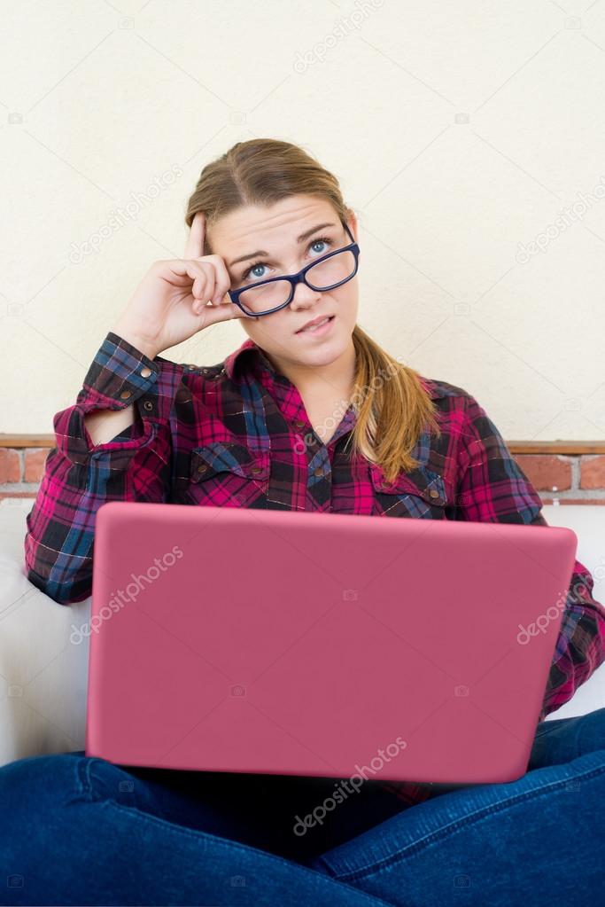 young girl with laptop with doubts