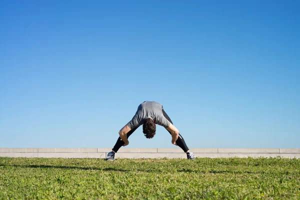 Man doing stretching before running space for text — Stock Photo, Image