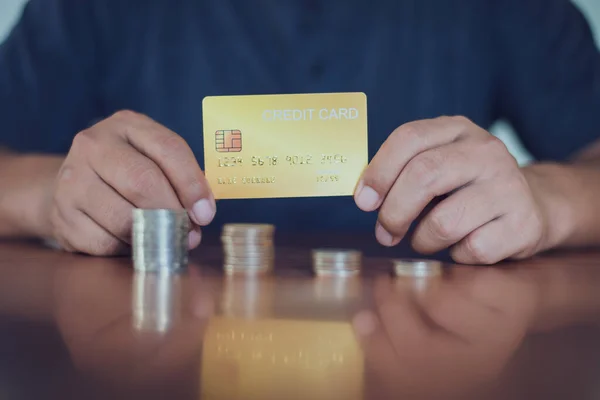 Man holding credit card with selective focus on the credit card, financial concept.