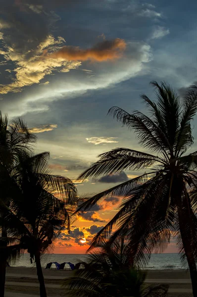 Multiple exposure of a sunset in a deserted Caribbean sea beach near Cartagena, Colombia.