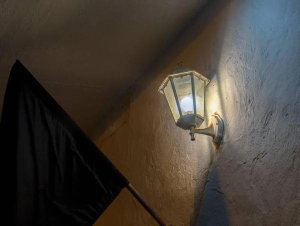 A vintage lantern turned on at a street of the colonial town of Villa de Leyva, in the Andean mountains of  central Colombia.