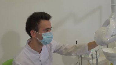 Diş Hekimi Bir Lamba Yıkıyor Diş Tedavi Odasında Bir Hastanın Hasta Kız Dişlerini İncelemeye Başlar Maskeli Genç Adam Doktor Aletlerle Çalışıyor