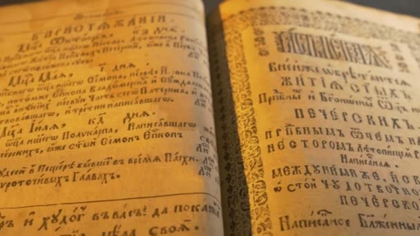 Ancient Slavic Style of Letters Patericon Panorama of a Book of Kiev-Pechersk Lavra Stories of a Lives of the Lavra's Saints Light of Candle in Dark Room — Stock Video