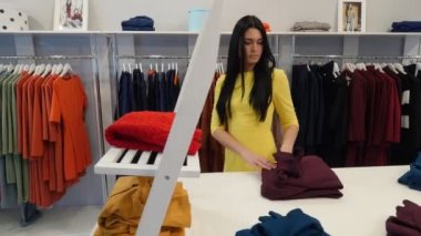 Woman Walking by Shop Takes a Red Sweater Tries it Choosing a Clothes Womenswear Shop Client Brunette Woman is Buying a Clothes Garments on a Trempels
