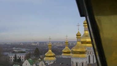 Golden Cupolas With Crosses of Holy Dormition Kiev-Pechersk Lavra Dormition Cathedral Kiev White Walls Green Roof Cityscape on a Horizon Cloudy Day
