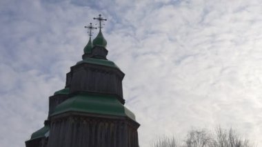Tower of Wooden Church Green Roofs Crosses on Top Winter Church of Paraskeva the Holy Martyr in Pirogovo Ukrainian Sacral Architecture Baroque Style