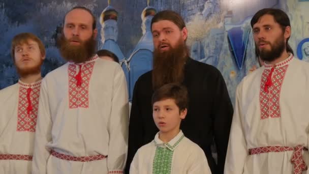 男子身着民族服装在拉夫拉圣诞庆典男童在衬衫唱圣诞歌曲宿舍大教堂乌克兰牧师在黑色 — 图库视频影像