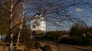 White Walls on Transfiguration Cathedral Bell Tower Golden Cupolas Behind a Branches Mgar Transfiguration Male Monastery Poltava Region Sunny Day Autumn