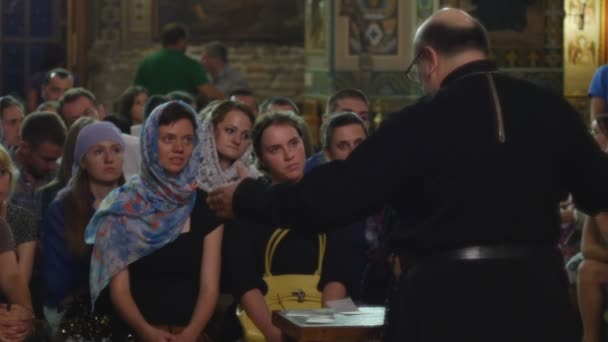 People in Holy Trinity Jonah's Monastery Kiev Ukraine Dormition of a Mary Interior of an Orthodox Church Women With Her Head Covered Sitting on a Benches — стокове відео