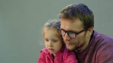 Baba ve çocuk vasıl belgili tanımlık perde birbirlerine baba kızının oynarken adam ve çocuk masada oturuyor Laptop ile çalışma öğretir konuşmayı arıyoruz