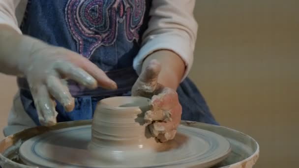 Kid is Molding a Vase Wheel Rotating Fast Girl Shapes a Vase With Her Thumbs and Smiling Talking to Someone Pottery Workshop Learning a Pottery Craft — Stock Video