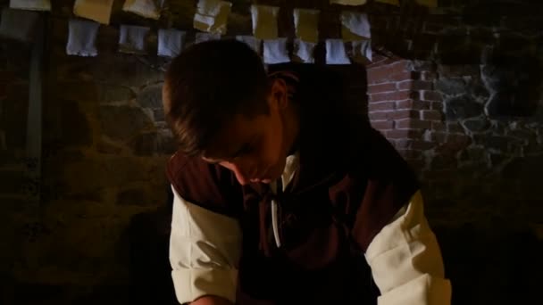 Guy Removes a Wet Paper Out of a Table Put Close to Light Papermaking Castle Museum Paper-Making Processes Guy in Folklore Costume Stage Radomyshl — Stock Video