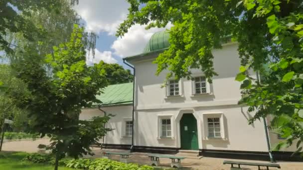 Entrance to Green Roofed Church Sunny Day Courtyard Panorama Footpaths Flower Beds Green Fresh Trees and Lawns White Walls and Small Windows Summer — Stock Video