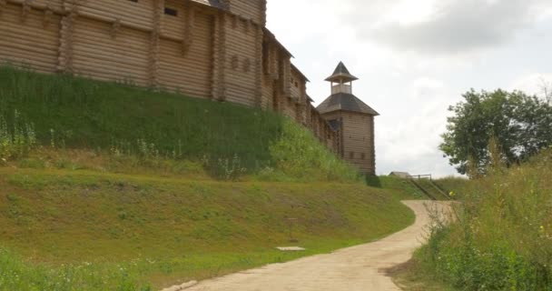 Fortaleza Colina, Paredes de la fortaleza, Paredes de madera, Paredes de troncos, Watchtowers, Derecho de seguimiento, Nubes grises, Verano, Soleado, Hierba verde, Kievan Russ, 11 Century — Vídeo de stock