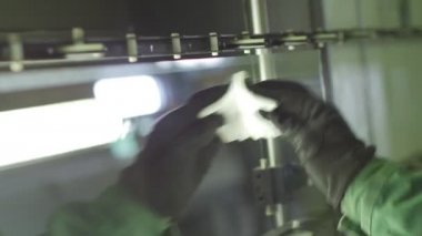 Worker's Hand in Glove Removes The Dirt With Rag Workshop Manufacturing of Glass for Glazed Windows