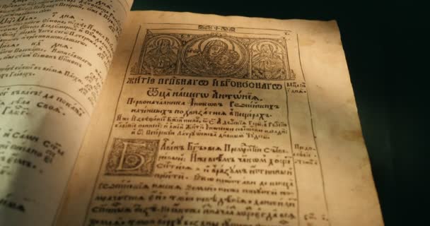 Old Book Paterik Of Kiev-Pecherska Lavra Old-Slavic Style of Writing Engravings Pictures Episodes from the Life of Saints Monks Turning Pages of Book — Stock Video