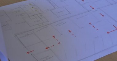 Woman's Hand Turns The Pages of Architectural Sketches Hand with Pen Woman in White Drawings Designs Schematic Drawn On Paper Indoors Kiev Ukraine