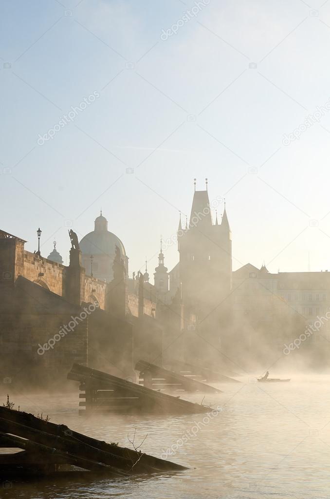 Charles bridge in Prague in the morning mist