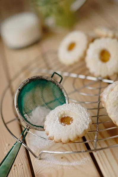 Linz biscuit with peach marmalade with a glass of milk in the ba