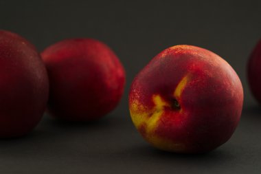 Red and yellow fruit nectarine on a dark  background