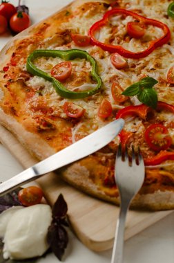 Delicious, freshly baked, homemade pizza with peppers, onions and basil