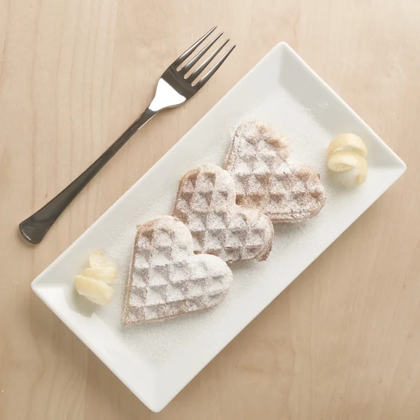 Heart waffles lemon zest, powdered sugar served on rectangular p — Stock Photo, Image
