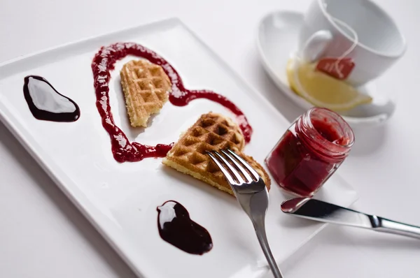 Heart shaped waffle, marmalade, chocolate sauce, vanilla sticks, — 스톡 사진