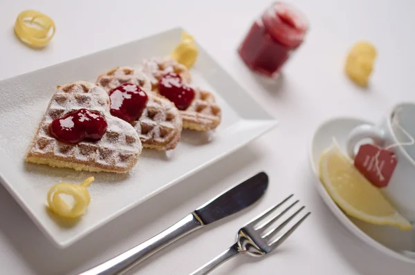 Heart waffles, marmalade, powdered sugar served on rectangular p — ストック写真