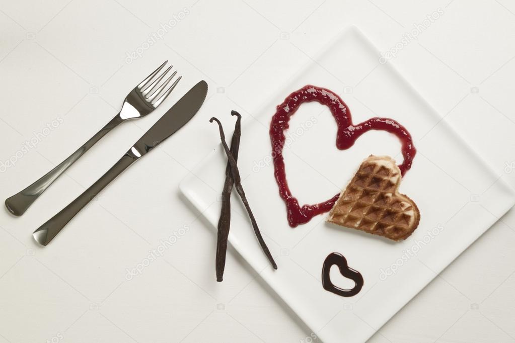Heart shaped waffles, marmalade, chocolate sauce, vanilla sticks