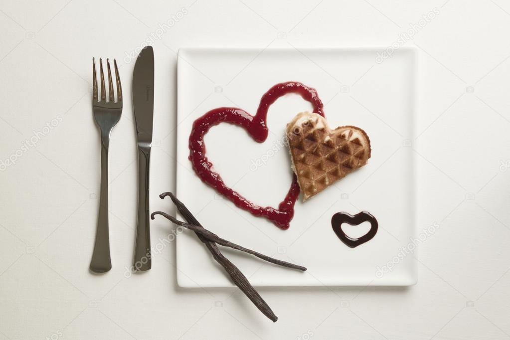 Heart shaped waffles, marmalade, chocolate sauce, vanilla sticks