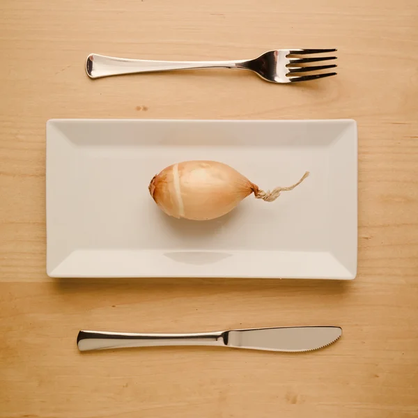 Vegan low-carb diet raw onion on rectangular plate