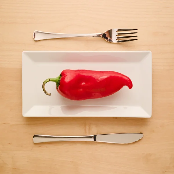 Vegan low-carb diet raw uncut red pepper on rectangular plate