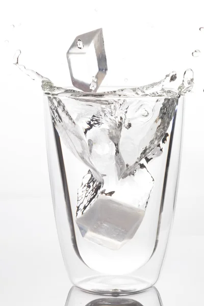 Ice drop to glass of drinking water — Stock Photo, Image