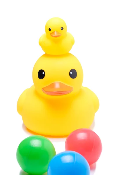 Yellow rubber duck with colorful ball — Stock Photo, Image