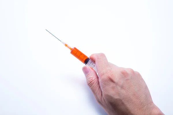 Hand holding red vaccine syringe — Stock Photo, Image