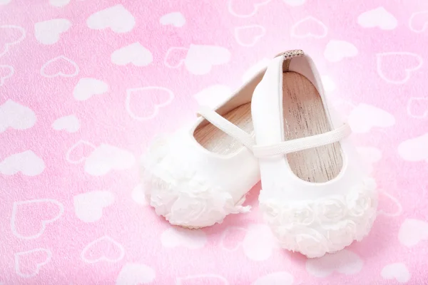 Cute baby shoes for kids on heart pink towel. — Stock Photo, Image