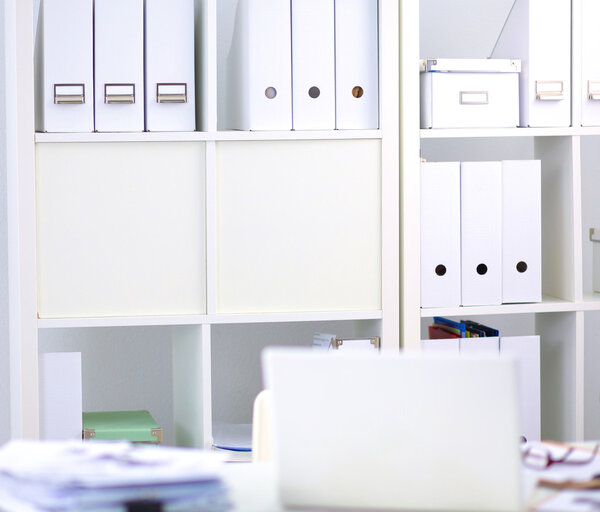 Desk of an artist with lots of stationery objects. Studio shot on wooden background