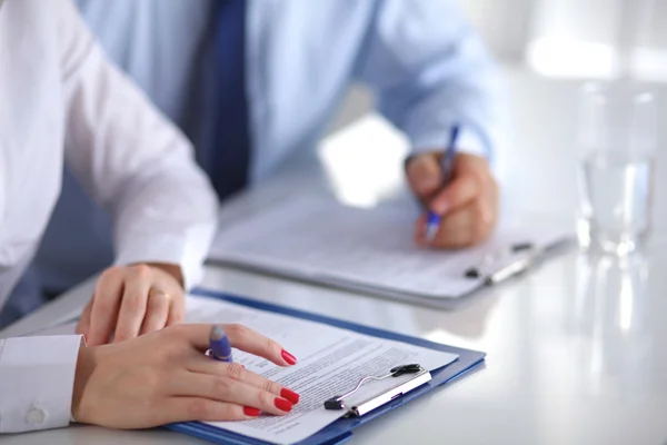 Image of business partners discussing documents and ideas at meeting Royalty Free Stock Photos