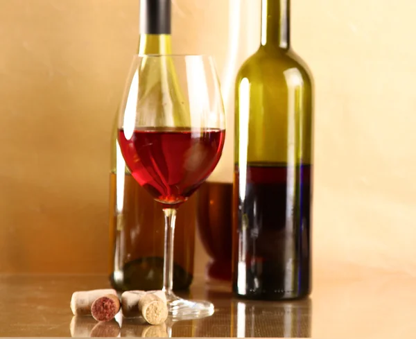 Botella de vino y copa de vino en una mesa de vidrio — Foto de Stock