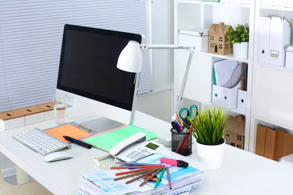 Table designer working space with a computer and paperwork — Stock Photo, Image