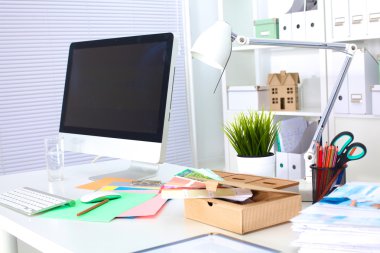 Bilgisayarı ve ahşap masasında akıllı telefonu olan bir ofis.