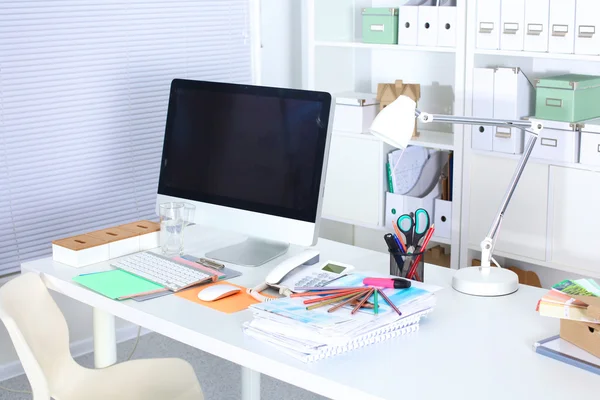 Bilgisayarı ve ahşap masasında akıllı telefonu olan bir ofis.