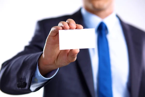 Mans hand showing business card - close seup shot on grey background — стоковое фото